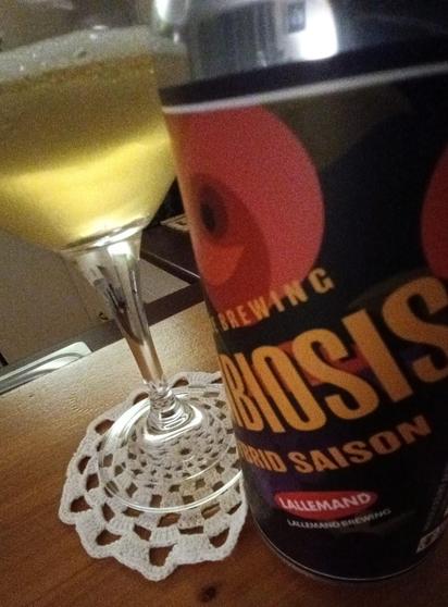 Close-up of can of Symbiosis craft beer  and Teku glass.