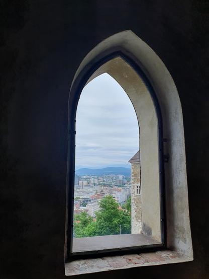 View from castle window, showing part of castle walls and city