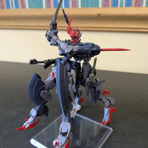 HG Barbataurus raised on a stand holding its sword with both hands in a pose as if it is prepared to chop down
