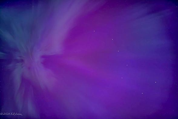 We were witnessing a historic, dazzling auroral display on May 10th, 2024 at Lake Sammamish in Redmond, Washington, where the Northern Lights captivated and mesmerized the onlookers with their vivid colors and fast moving formations.
The dancing ribbons of light surrounded, enveloped us with vibrant colors, sometimes radiating directly overhead where the Big Dipper’s seven bright stars aligned with the Coronae (Corona Borealis or crown), a rare event, indeed.
The Corona is the most impressive type of aurora, when rays or rayed bands pass overhead to converge to a point to form a crown or corona. So we looked overhead and the aurora rays appeared to originate from one single point and radiated outwards, in alignment with Big Dipper.
Words escape me to describe how mind-blowing was this otherworldly, once in a lifetime experience, to witness the vivid display of the aurora borealis as the lights filled the night sky with swirls of purple and blue hues.
The natural phenomenon created an ethereal atmosphere, conveying the beauty of Earth's geomagnetic interactions with solar particles.