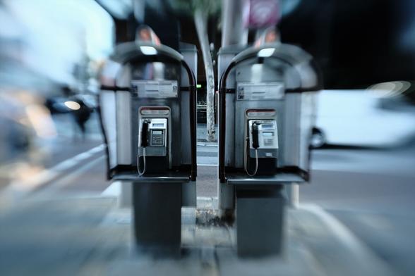 Two telephone booths stand awaiting their next call