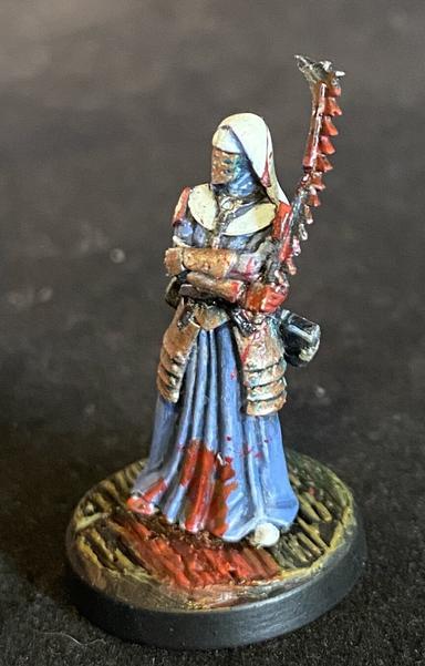 A stoic, blood-drenched Trench Crusade combat medic standing with arms crossed.