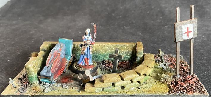 A diorama of a combat medic standing next to a deceased patient.