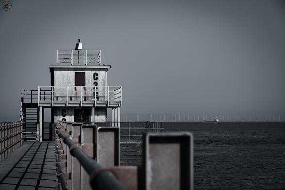 Shot following railings leading up to old harbour tower, desaturated shot to give grey appearance