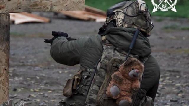 A soldier says he found a toy on a destroyed playground. Photo: Command of the Special Operations Forces of the Armed Forces of Ukraine