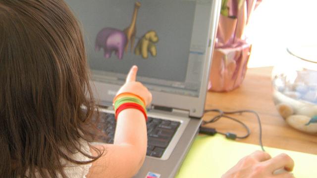 minimalist design MNML/WWF - child points to a digital rendering on a laptop