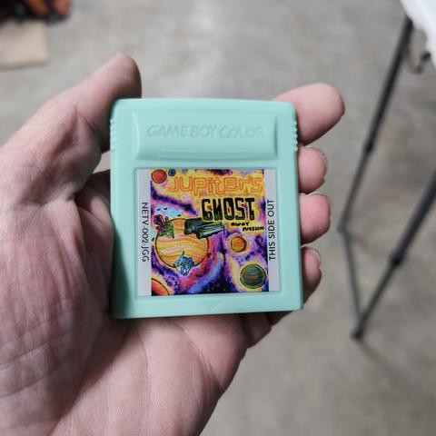 A gameboy color cartridge with the Jupiter's Ghost cartridge art printed directly onto the cartridge, rather than printed on a sticker.