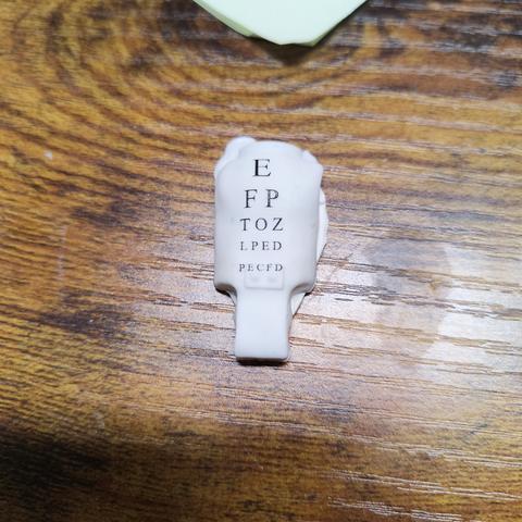 some letters printed directly onto a white action figure torso. It says E FP TOZ LPED PECFD. Each row is smaller than the previous row. 

This is to showcase how small we can print the details.