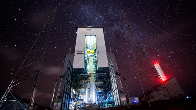 Night time at a giant rocket hanger. Night time at a giant rocket hanger.