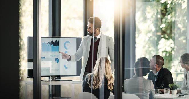 Accounting, business people and budget meeting with charts, fintech and speaker for profit review. Presenter, audit and financial report with technology for graphs and revenue results in office.