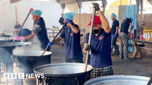 Cooks stir pots of rice and lentils at a community food kitchen run by the US-based humanitarian organisation Anera in Khan Younis, southern Gaza