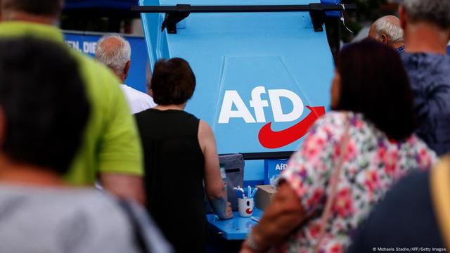  The logo of far-right Alternative for Germany (AfD) party is seen on a stand as supporters gather for an AfD election campaign meeting in Weisswasser, Saxony