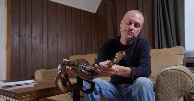 Tim Friede at home in Wisconsin with a snake.
