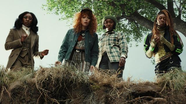 Cynthia Erivo as triplets and Natasha Lyonne as Charlie Cale look into a hole in the ground in a still from 'Poker Face' Season 2.