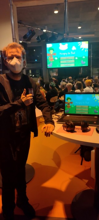 me standing infront of a monitor and a laptop showing my game
