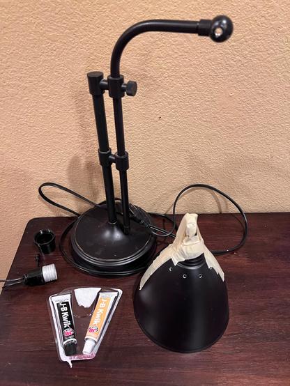 Broken old brass lamp being glued fixed 