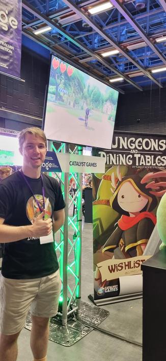 Luke at the Dungeons and Dining Tables stall at SAGE 2025