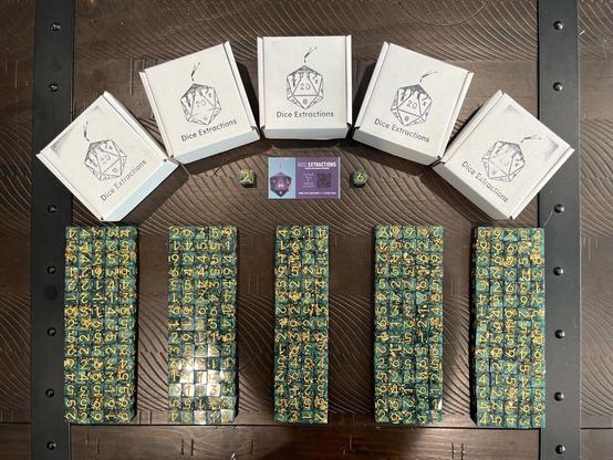 Green d6 dice with large gold numerals, lined up and getting ready to be shipped from the makers. Pic courtesy Dice Extractions.