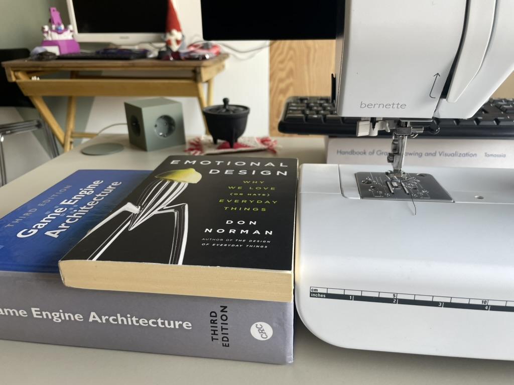 Other books being used to prop up sewing project to the sewing machine height. (Game Engine Architecture and Emotional Design)