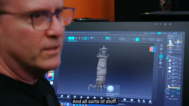 Screenshot of the documentary showing an artist being interviewed and their computer monitory displaying the game's player character they're working on.