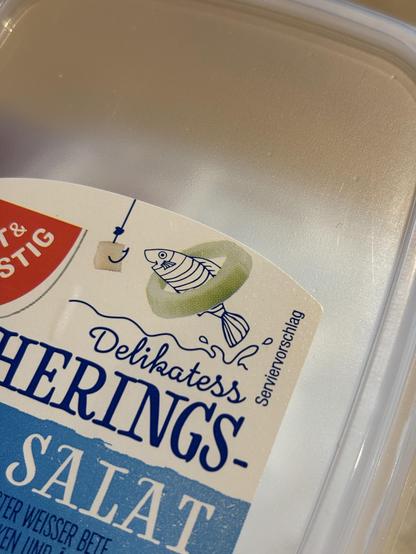 German packaging for Herring salad showing the word serving suggestion next to a cartoon fish inside a piece of onion