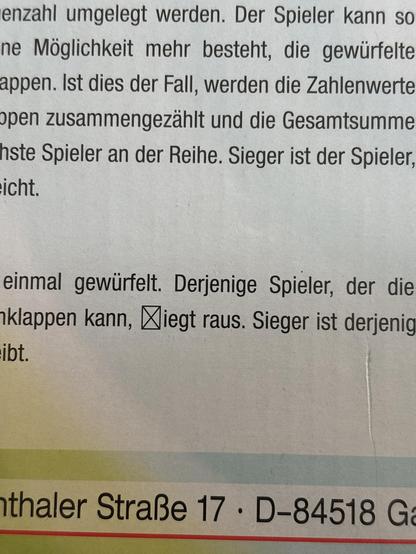 Back of a game packaging with german instructions. On the word “fliegt” there’s crossed out box where the letters fl should be.