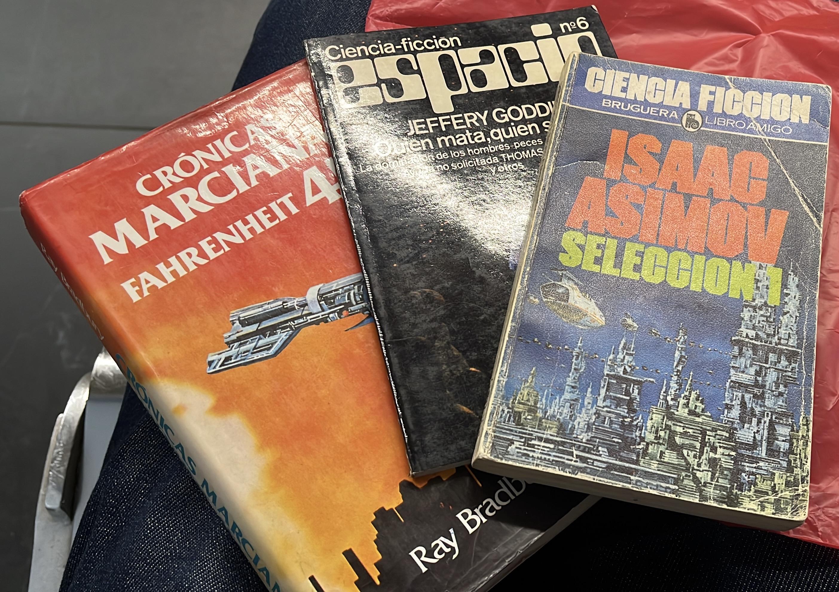 A collection of three science fiction books, including "Crónicas Marcianas" by Ray Bradbury, "Espacio" featuring a story by Jeffery Goddard, and "Selección 1" by Isaac Asimov