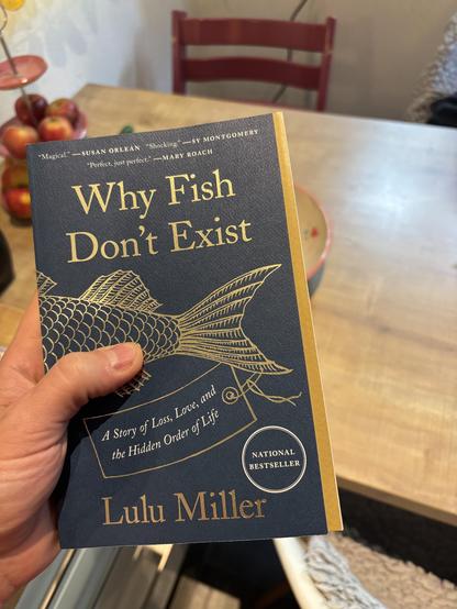 Cool cover design of “Why Fish Don’t Exist” by Lulu Miller. The right side of the cover is a small golden stripe.