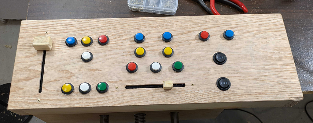 Finished button box prototype for Elite Dangerous.  Has a slider on the left for throttle, another slider on the bottom-center for sensor tuning, a bunch of buttons for power distribution, navigation and targeting, etc.  Also a couple of switches for landing gear/cargo scoop and ship headlights/night vision.