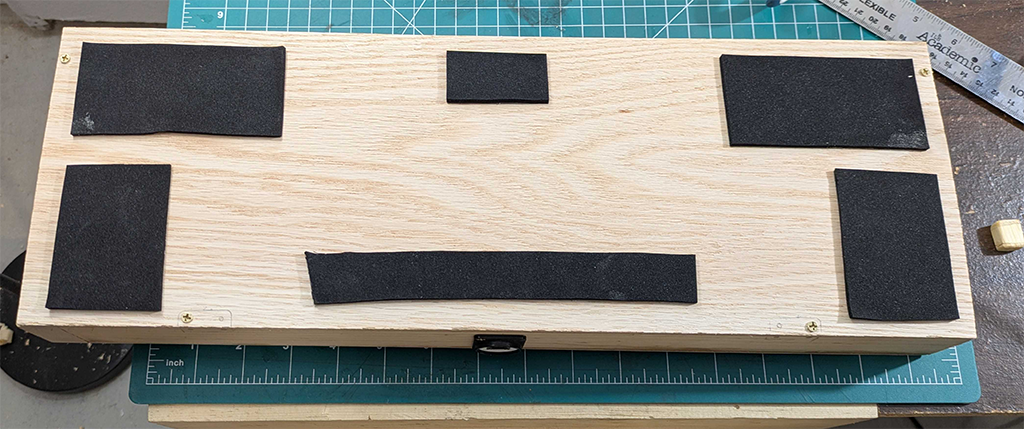 Bottom shot of the button box showing some scrap neoprene padding to give it a non-slip bottom.
