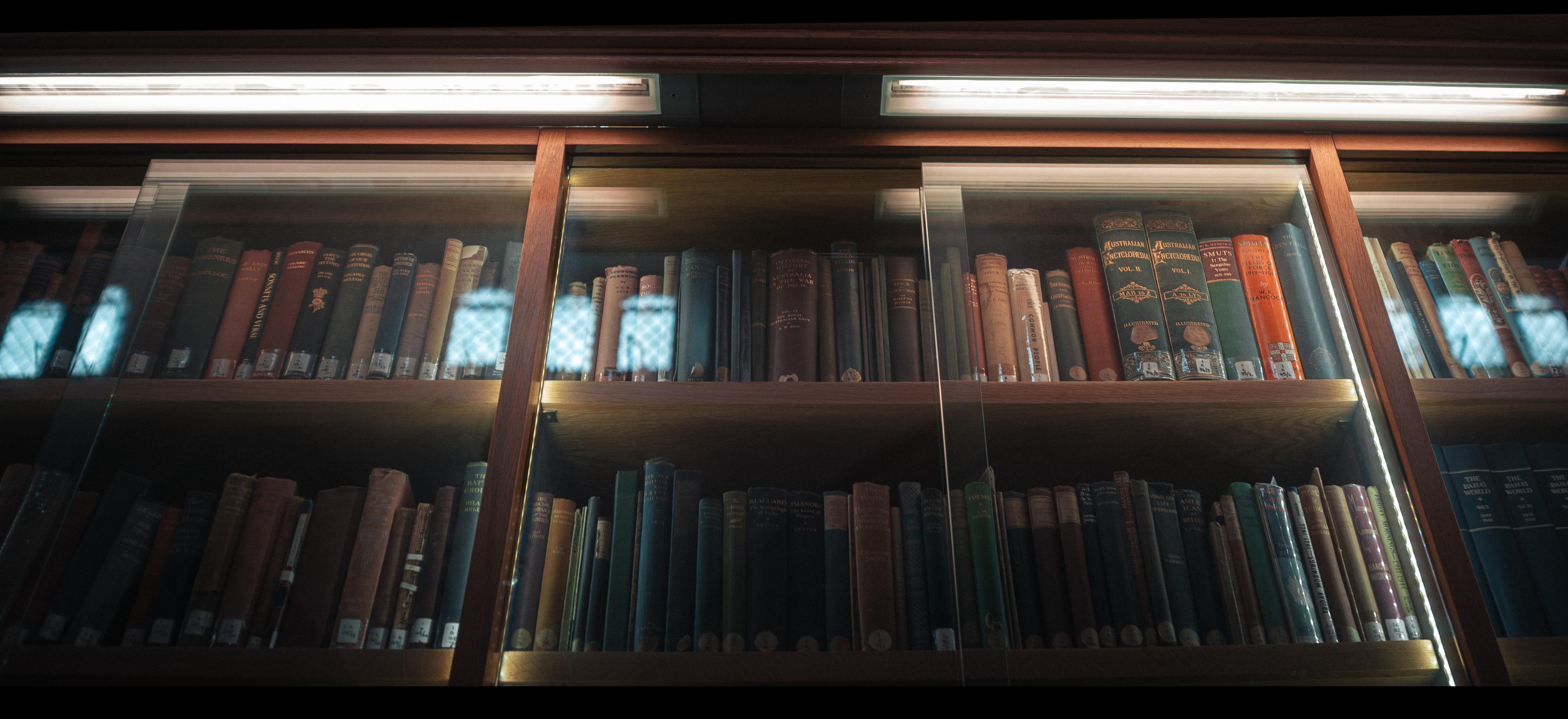 Books in their illuminated and secure glass cabinet to stop dangerous books getting you with their words.