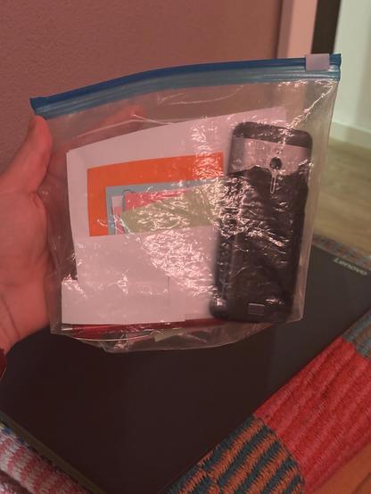 a ziplock bag full of paper and an old
mobile phone