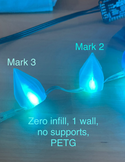 Photo of two different designs for crystal shapes that cover blue LEDs. The designs are labeled Mark 3 and Mark 2.