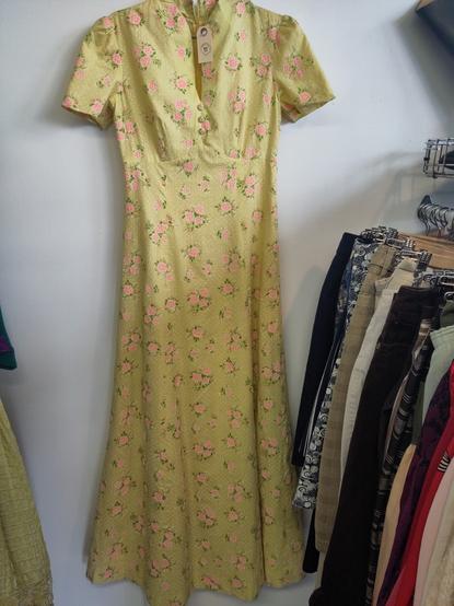 a yellow sun dress hangs on  the wall
