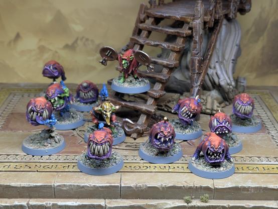 10 red and purple squigs and two goblin handlers.