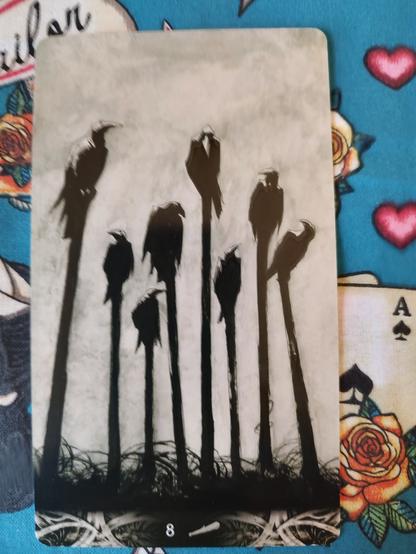 Card from the Murder of Crows Tarot deck. 
Eight of Wands. 
Eight crows perching on 8 staves (wands) sticking out of the ground.