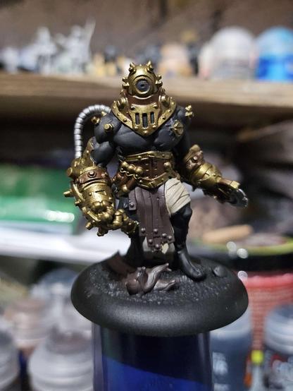 A miniature from the Cephalyx Criterion unit for Warmachine, with the Bronze brass, leather and bandages just base coated, the rest of the mini left black.