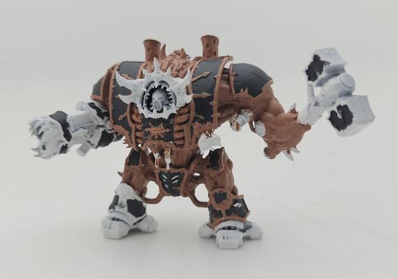A hellbrute painted with a dark flesh colour and black armour panels