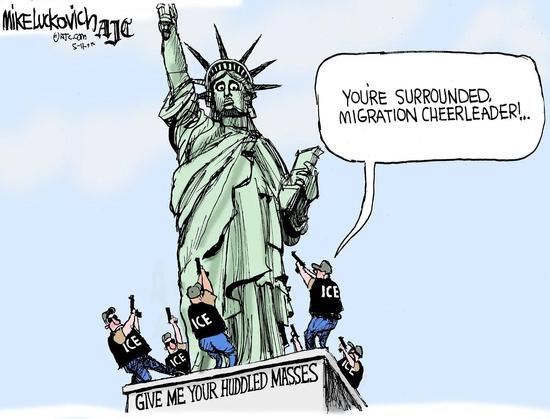 A political cartoon featuring the Statue of Liberty, with several men in "ICE" shirts pointing guns at her. The statue has a speech bubble saying, "YOU'RE SURROUNDED. MIGRATION CHEERLEADER!..." The base of