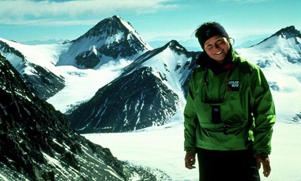 Alison Hargreaves in the Himalayas. She's a white woman with blonde hair, in a heavy green coat. She's smiling.