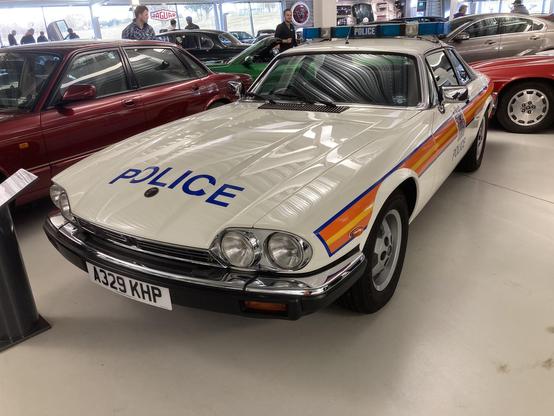 White Jaguar XJ-S in British police livery, front quarter view