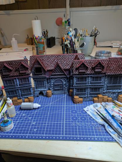 Three 3d printed sections of a dungeon master screen, first base coats painted on, some dry brushing and washing done