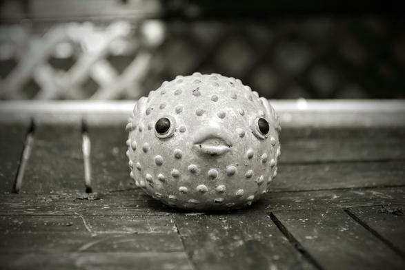 the figure of a puffer fish on a table surface