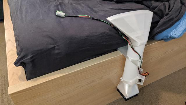 bed cooler prototype attached to an unmade bed