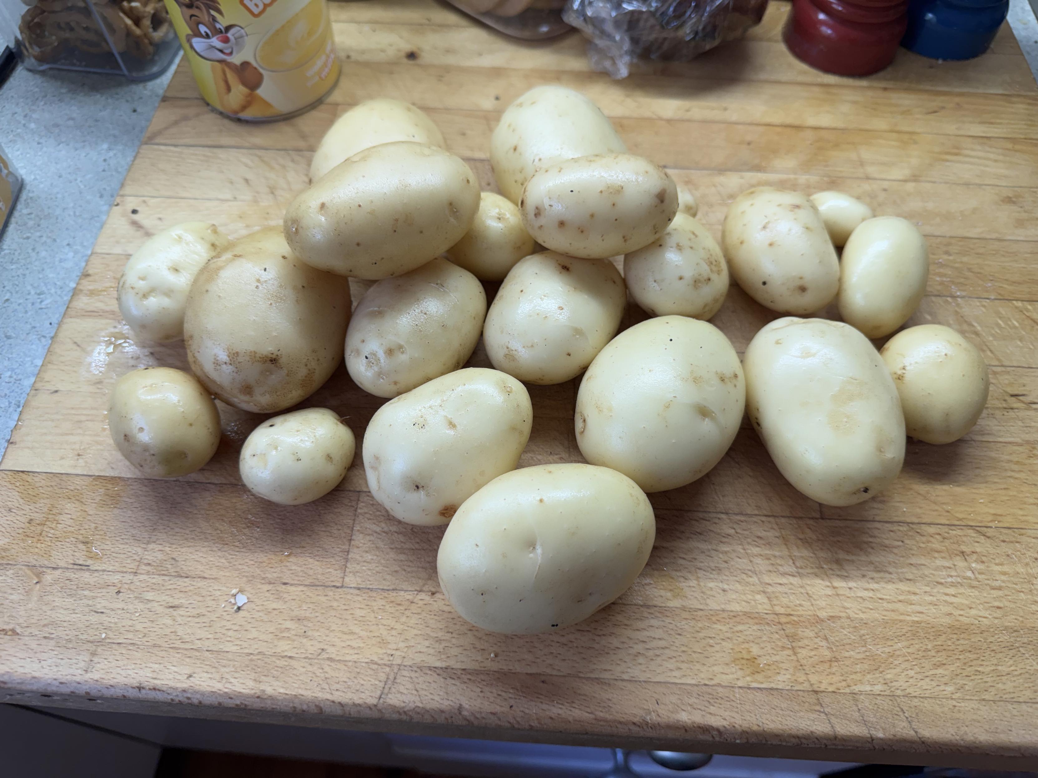 Small pile of cream coloured newly dug potatoes.