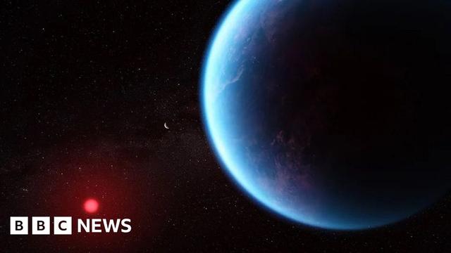 Blue planet in the Foreground orbiting a small red star