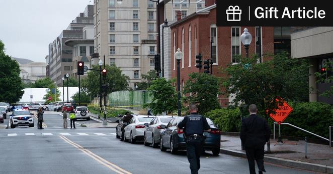 Law enforcement officials walked toward the site of the shooting near the Capital Jewish Museum in Washington, D.C., on Thursday. 