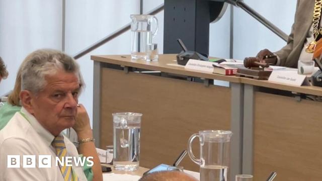 Nottinghamshire County Councillor Bert Bingham is pictured wearing a white shirt with yellow and grey-striped tie
