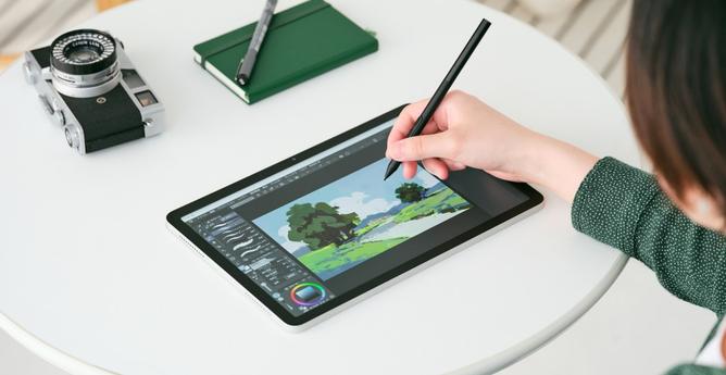 The Wacom MovinkPad 11 being used on a white table.
