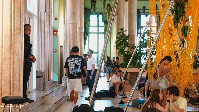 People relax in a Madrid heat shelter full of plants and hammocks